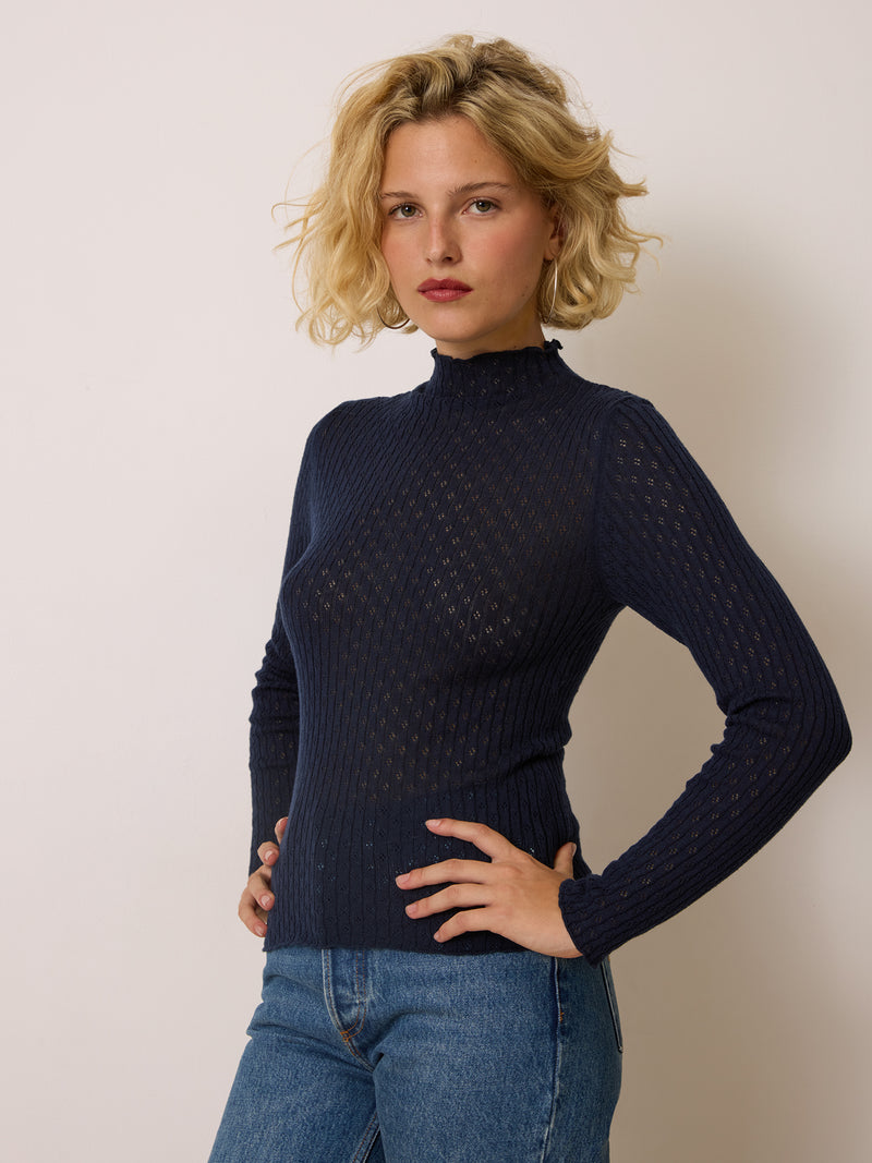 GALINA blue openwork turtleneck sweater worn on a model by Rouje